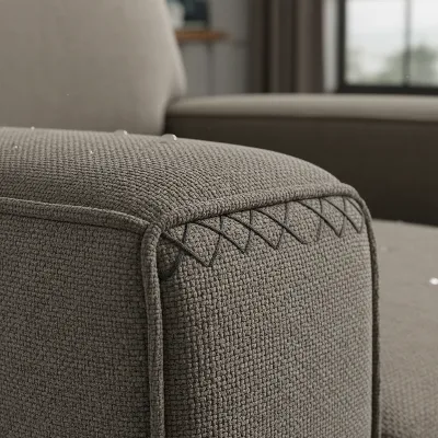 Close-up of a durable, stain-resistant fabric on a recliner, highlighting the texture and strong stitching.