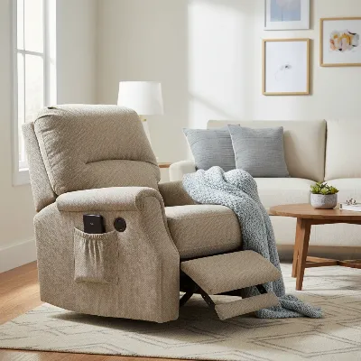 A comfortable Raymour & Flanigan power recliner in a modern living room setting, with a remote control and USB port visible on the side.