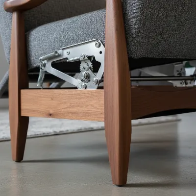Close-up detail of a recliner's push-back mechanism and solid wood frame for durability